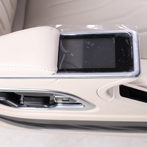 Touch control screen on the armrest of the van seat